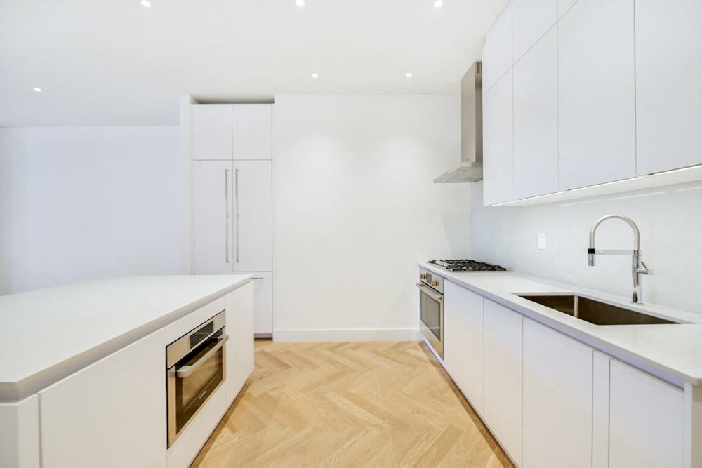 a kitchen with white cabinets and a sink